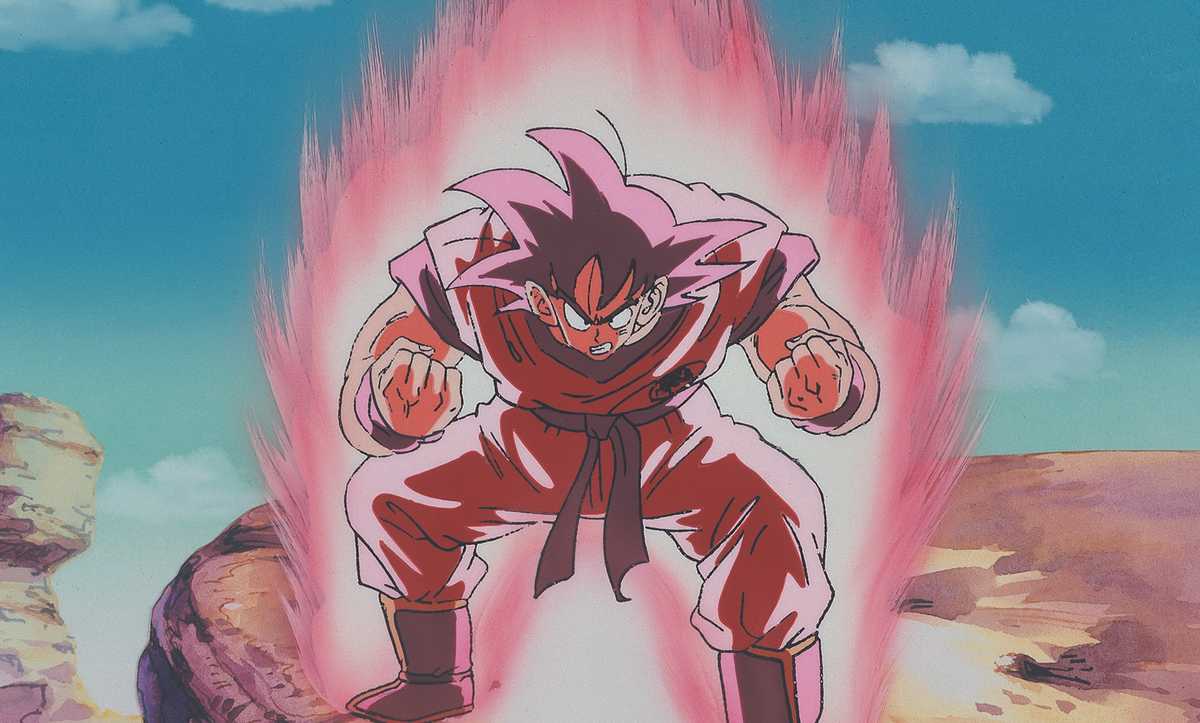 Goku hunched over in a powerful stance, powers up with a fiery pink aura